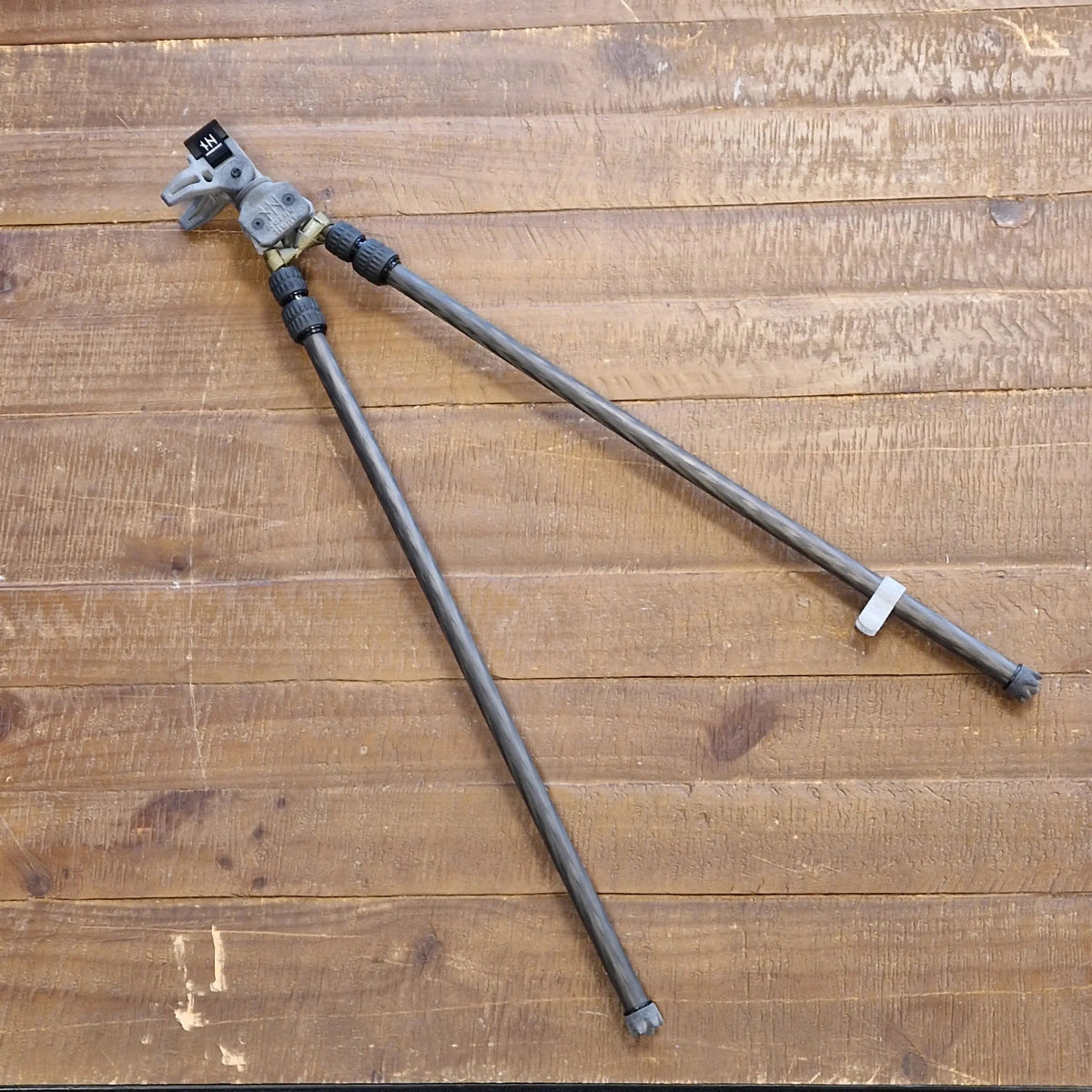 NorneHunt shooting sticks laid on wooden boards with their carbon fibre legs spread apart.