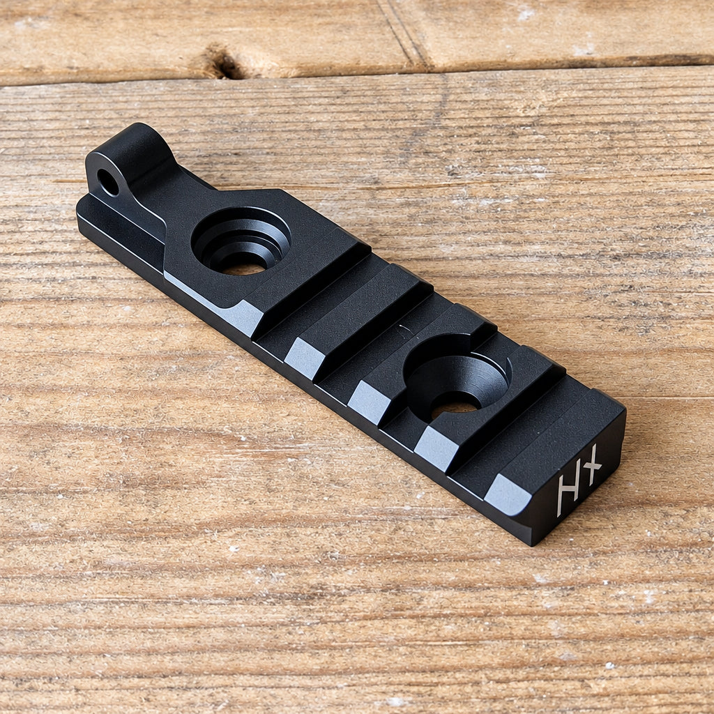NorneHunt Standard Picatinny rail showing its mounting holes, rail slots and sling attachment point.