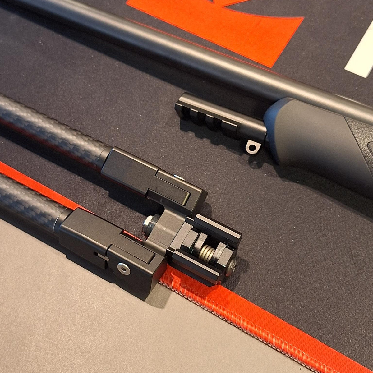 Sauer 404/505 Picatinny adapter fitted to a rifle, with a detached Picatinny clamp alongside