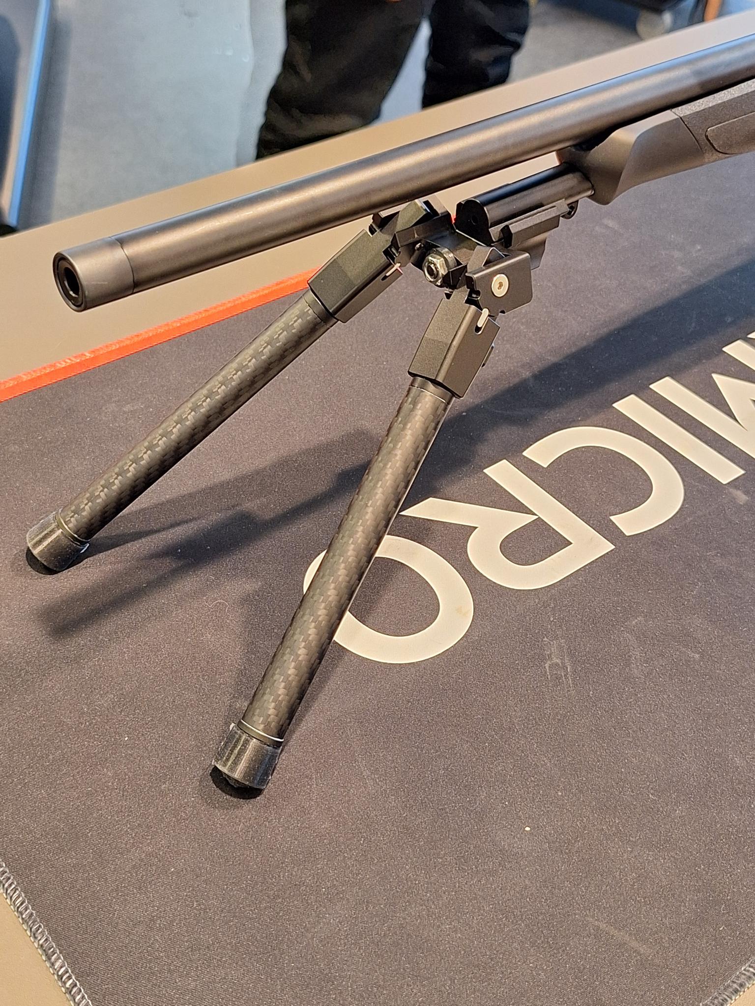 Picatinny adapter for Sauer 404/505 mounted with bipod on a rifle showing functionality and design.